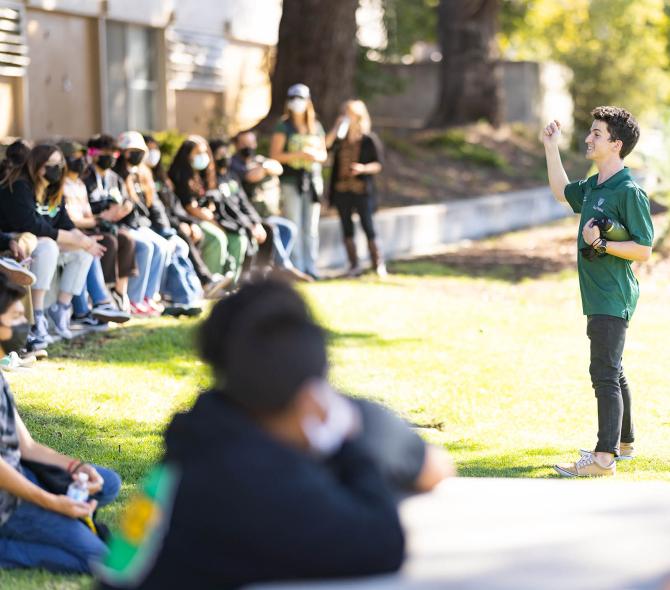 Cal Poly tour guide speaks to a large group of students taking a tour of the campus. 