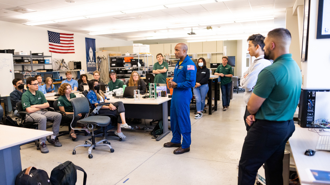 Inside the CubeSat lab, Captain Victor Glover talks to students about his experience on the International Space Station.