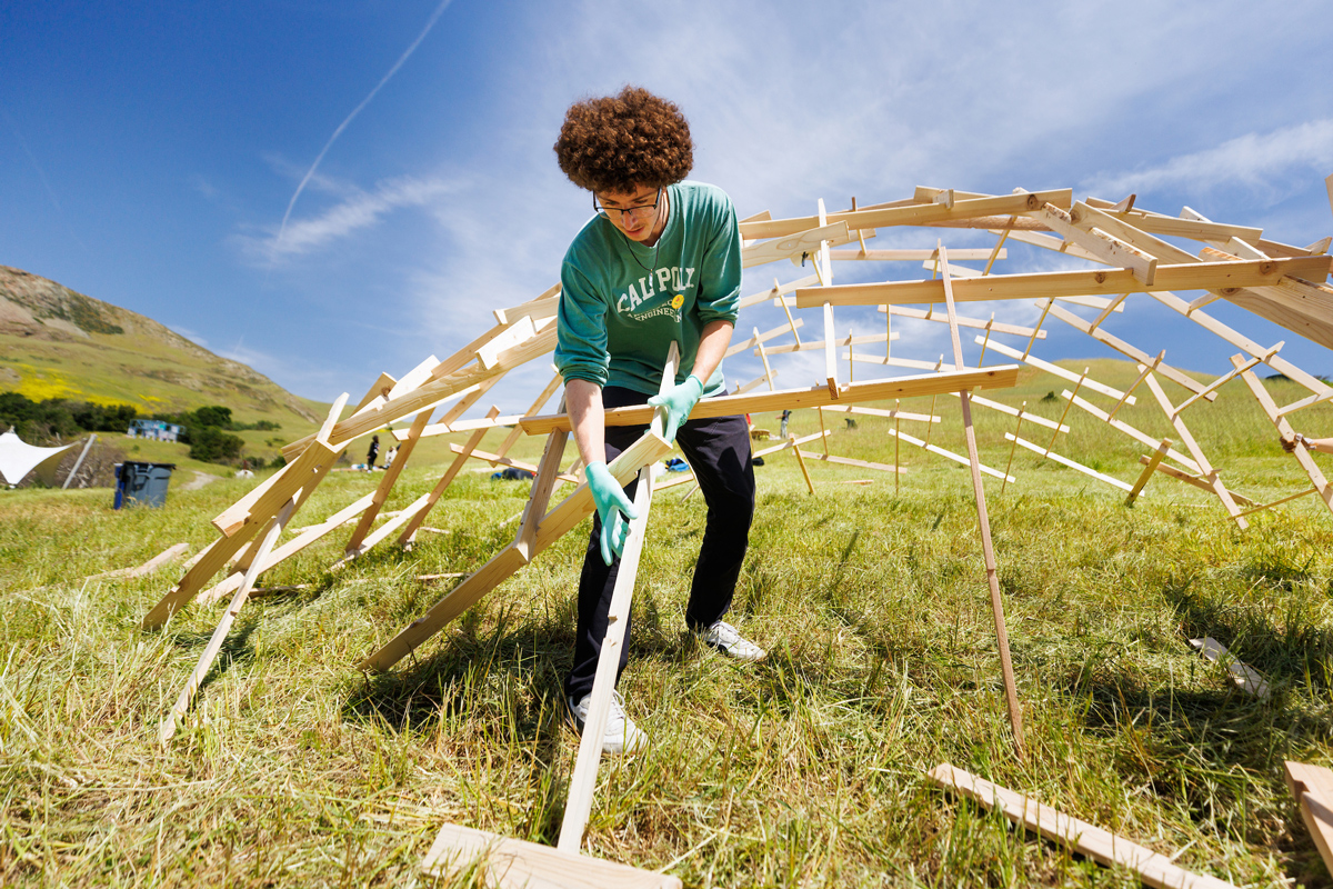 One student works on a domed wooden structure for Design Village. The theme this year was “Biophilia,” the innate human instinct to connect with nature and other living beings