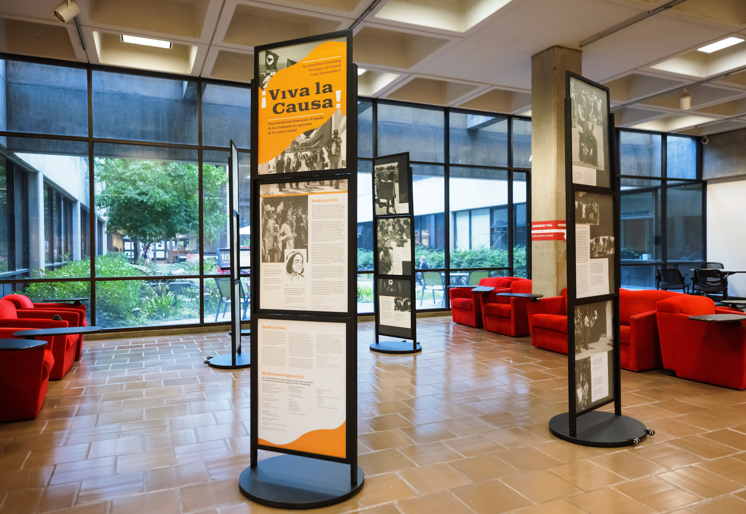 Four vertical informational posters in a circle in the main area of the Kennedy Library.