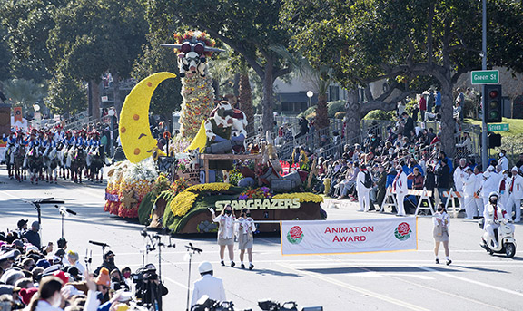 Cal Poly universities' Stargrazers float appears in the Rose Parade, led by the banner annoucing the Animation Award
