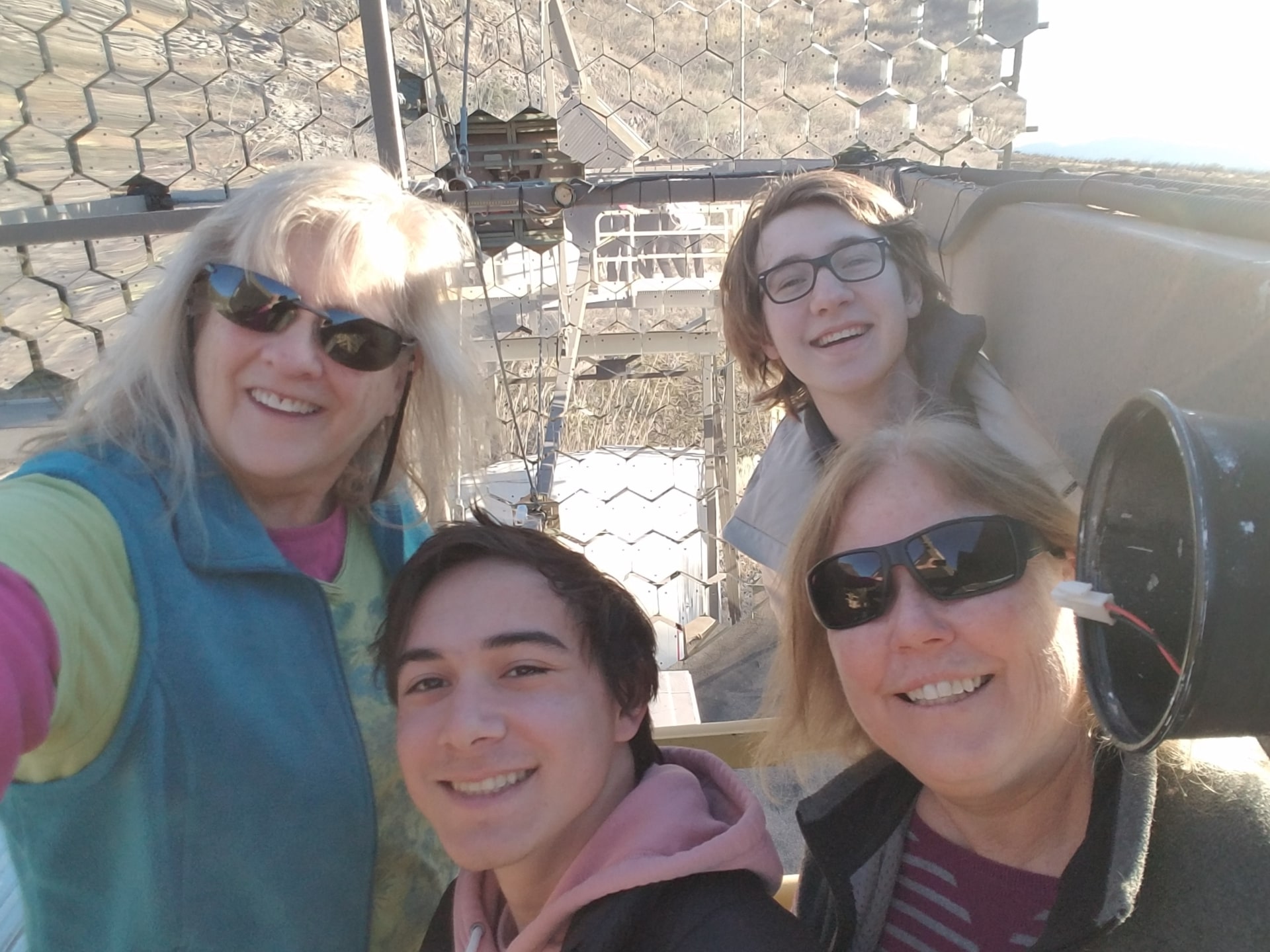 Two professors and two students take a selfie at the VERITAS site.