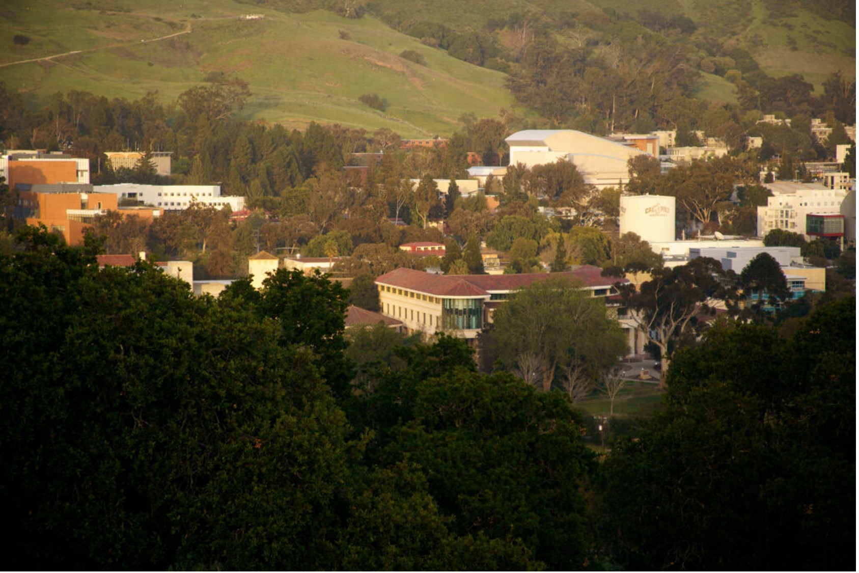 The Cal Poly campus, including the Orfalea College of Business building, seen from an aerial view.