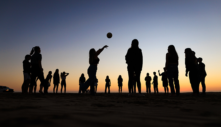 Students play volleyball during a Cal Poly Week of Welcome WOW bonfire in Grover Beach.