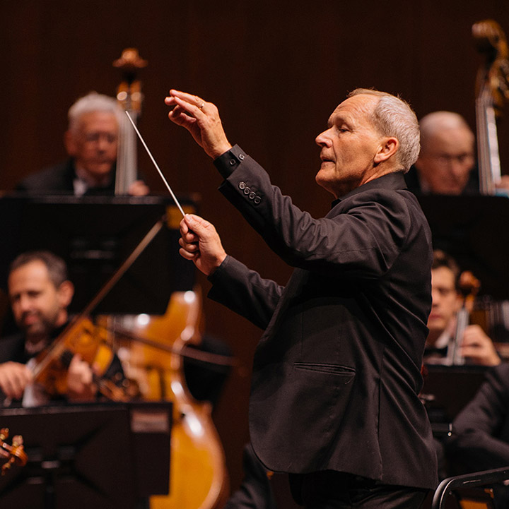 A conductor during a performance of the SLO Symphony