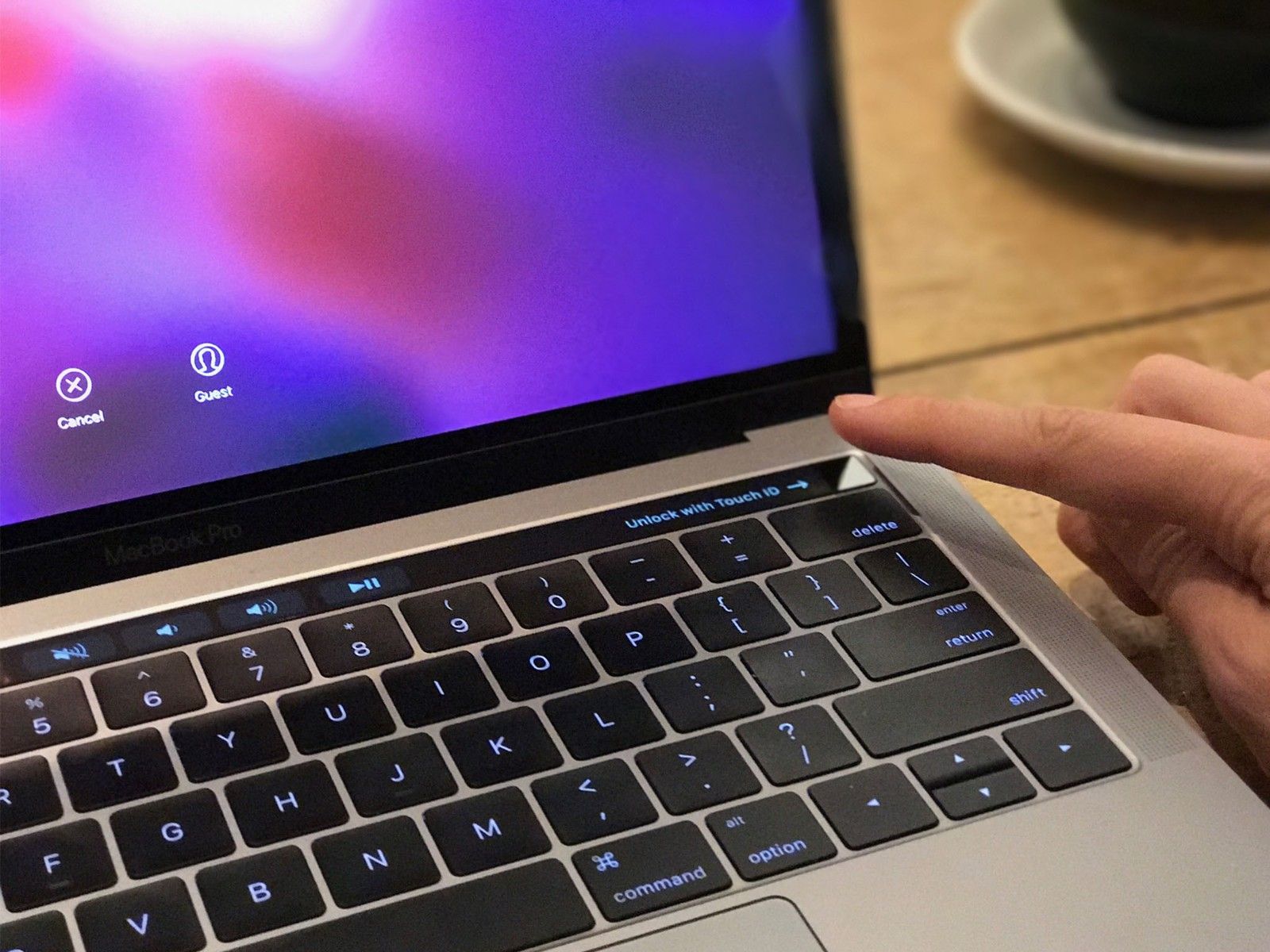 Person using at finger pad on their Macbook. 