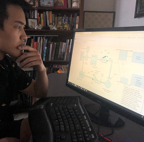 Mechanical engineering student Cameron Wong analyzes a diagram of a medical ventilator on his computer screen.