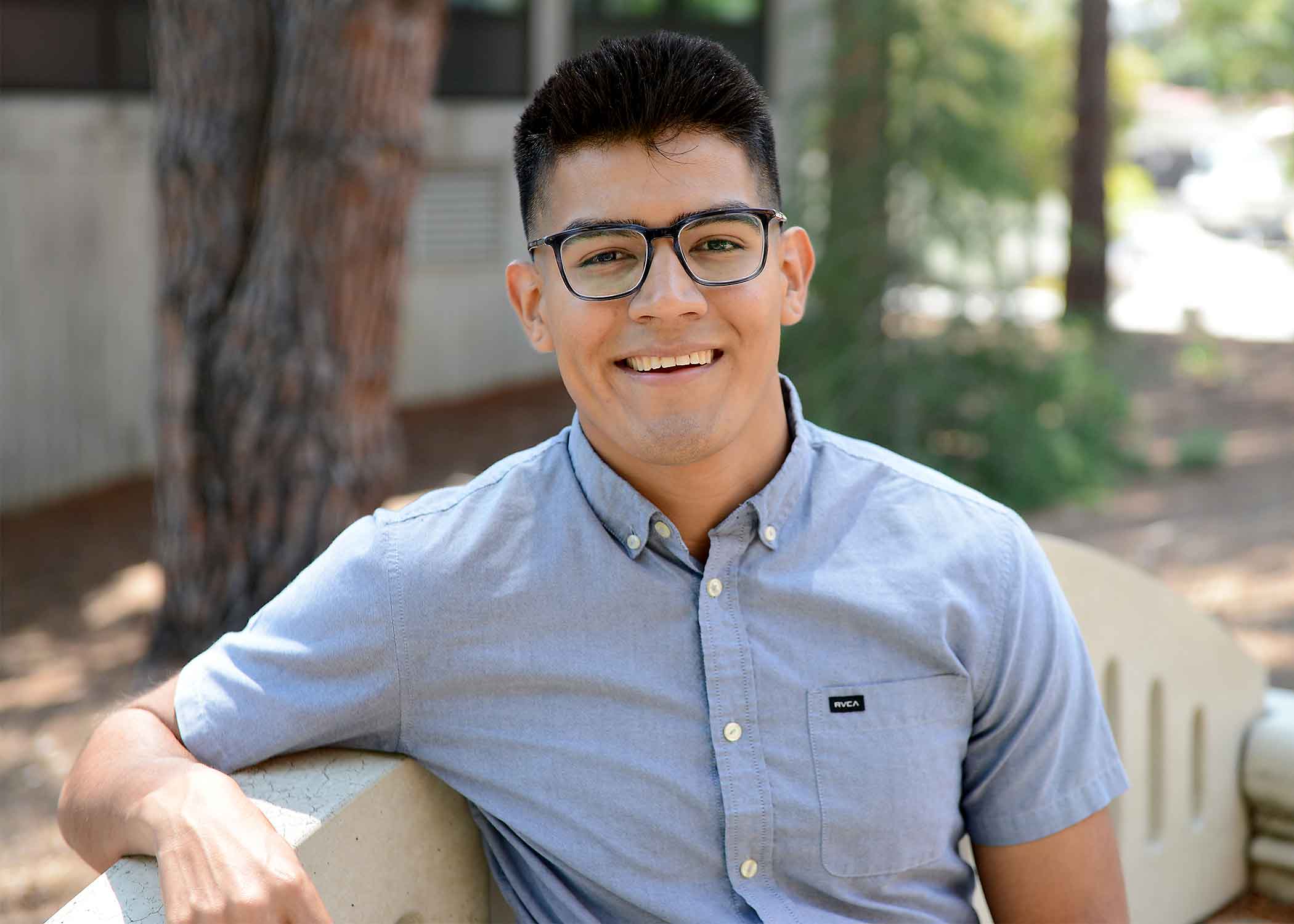 Antonio Aguilar Gomez, a 2019 Cal Poly graduate, smiles on campus. 