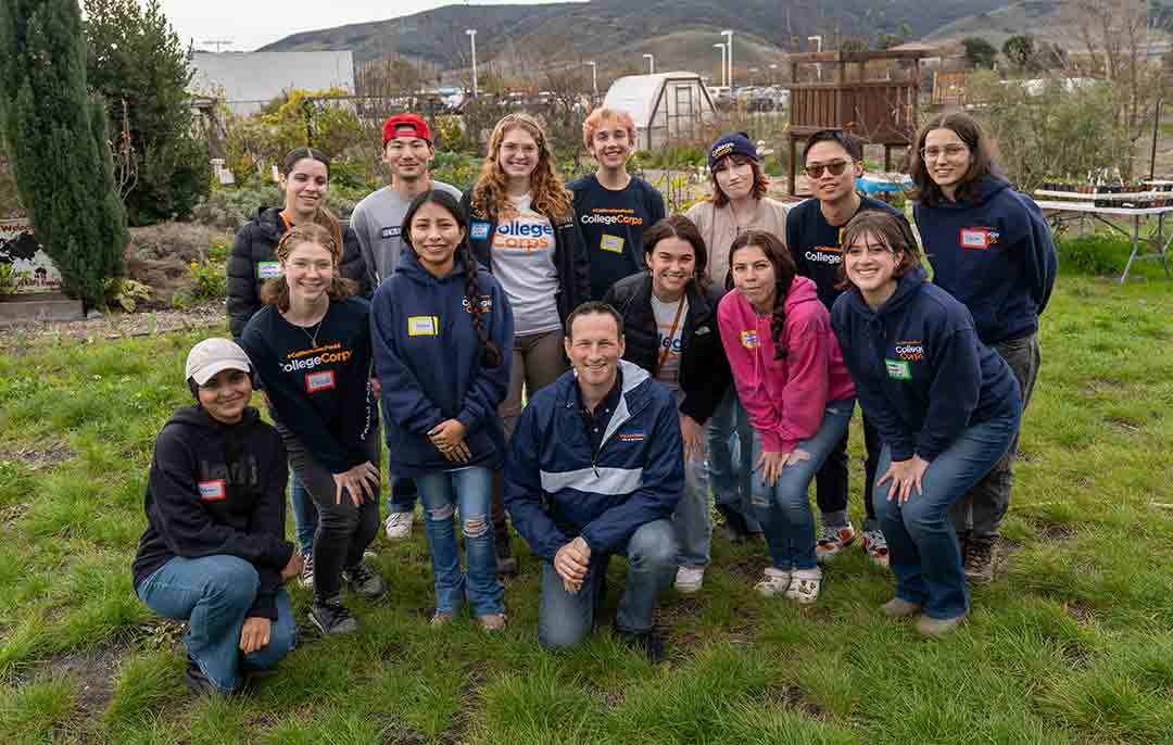A group of Cal Poly students volunteering with #CaliforniansforAll College Corps pose for a photo at City Farm SLO.
