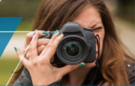 Photo of woman holding a camera to her face