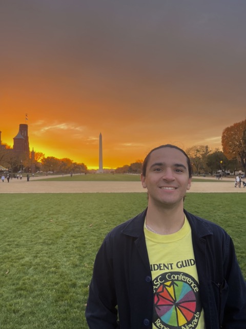 Ethan Gutterman smiles for a photo at sunset in Washington, D.C., with the Washington Monument in the background.
