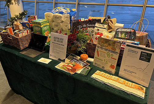 A table is filled with nonperishable food and personal hygiene products donated by employees at the campus holiday reception on Dec. 1.