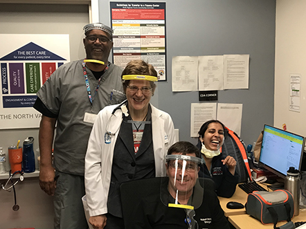 Four doctors wearing protective face shields. 