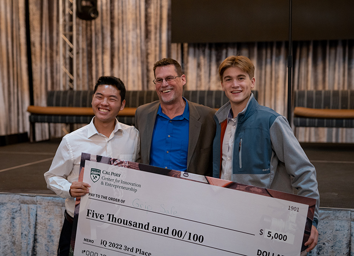  Third place award winners of Innovation Quest 2022: GripSafe Founder Shaun Tanaka (left) along with engineer Dylan DeFazio (right) and one of their mentors, Jim Finwick (center).