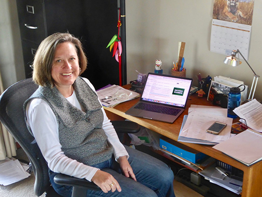 Professor Karla Carichner at her desk at home, preparing to teach a class remotely.