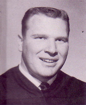 A black and white head shot of John Madden in 1958