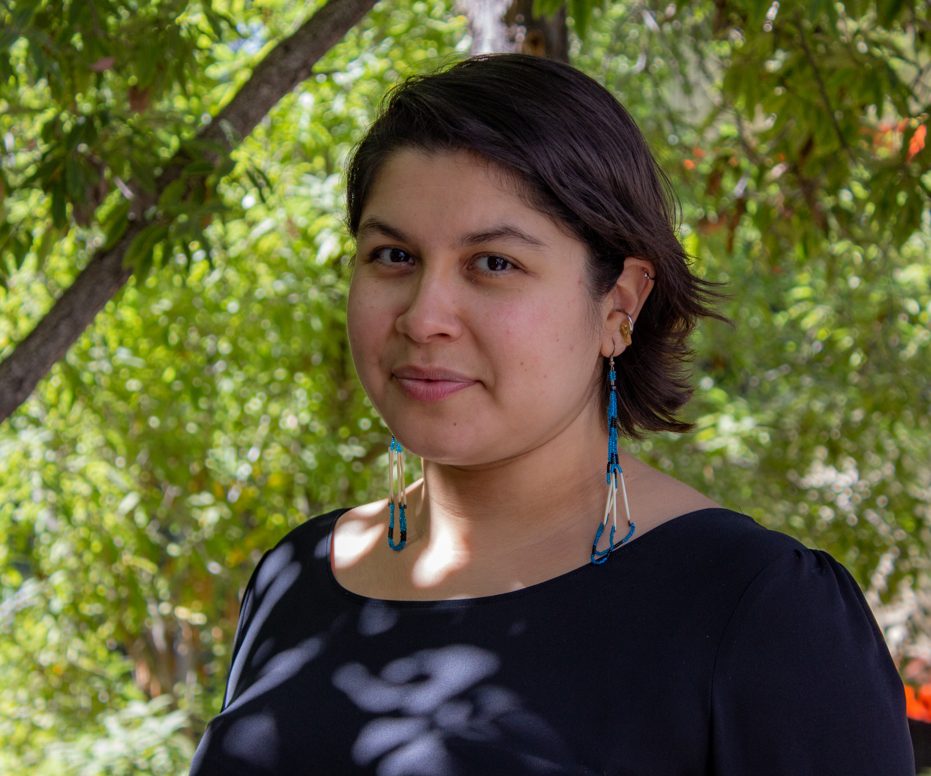 A headshot of professor Shanae Martinez in a dark blouse.