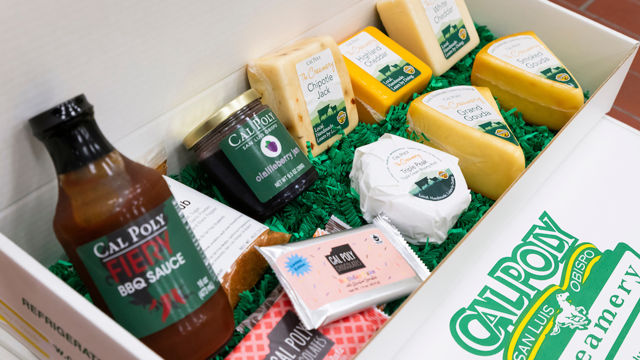 A gift box full of Cal Poly student-made food products, including cheese, jam, barbecue sauce and chocolate bars