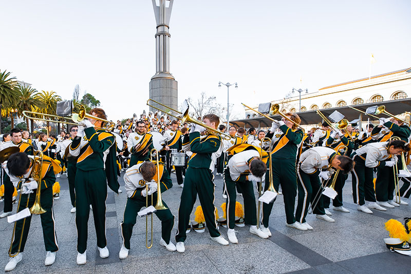 The Mustang Band performing and dancing in front of the Ferry Building in San Francisco