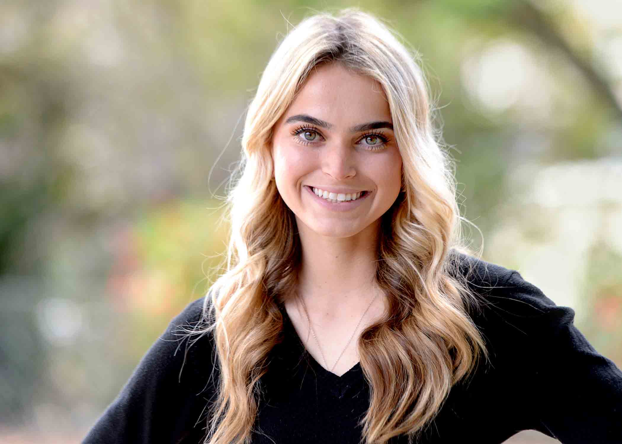 Nikki Trucco wears a black shirt and smiles for her headshot.