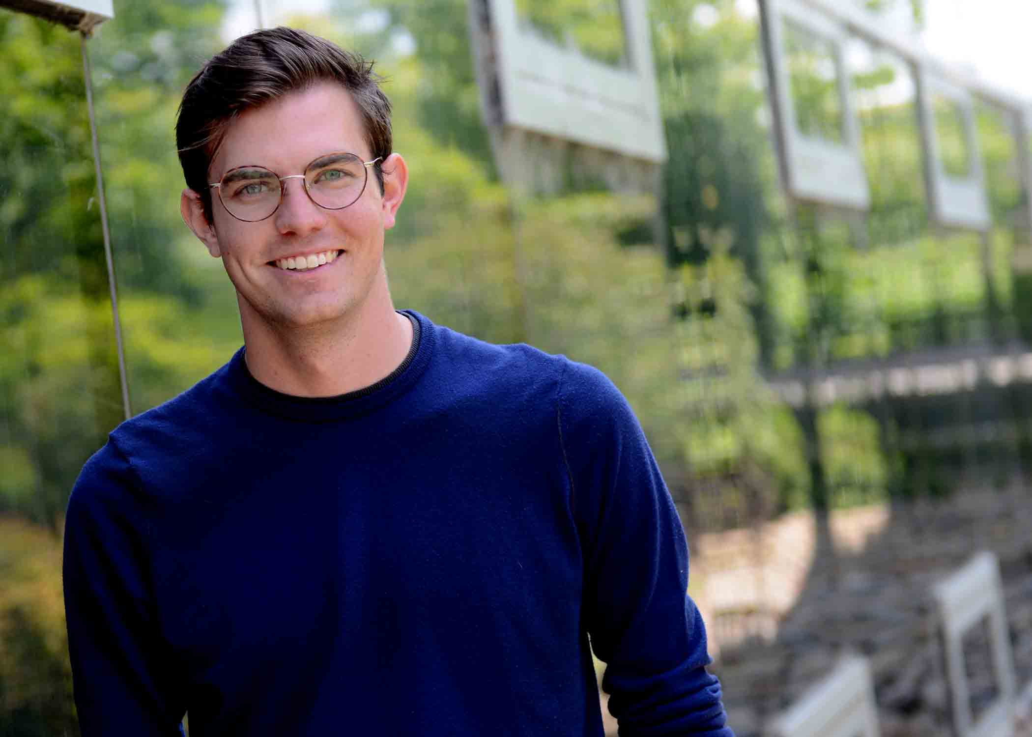 Student and soon-to-be graduate Matthew Bornhorst smiles for a professional headshot.