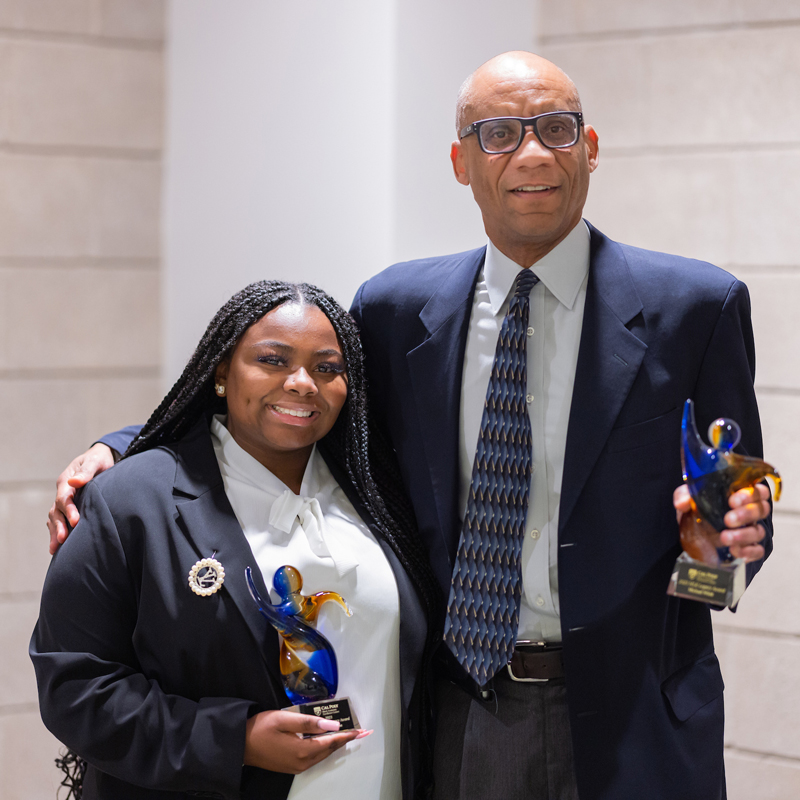 Nailah DuBose and Professor Michael Whitt smile with their MLK Awards in hand