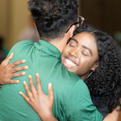 Two people embrace during the PolyCultural Weekend event in 2019. 