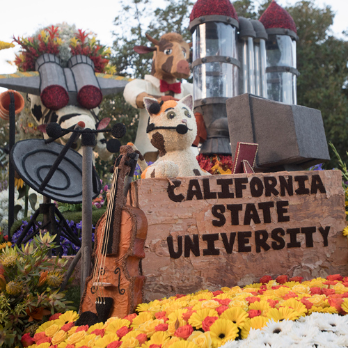 A portion of the Cal Poly Rose Float featuring a cat a cow with a sign reading Cal Poly Universities