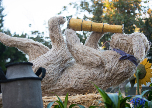 A portion of the Cal Poly Rose Float featuring a dog holding a telescope