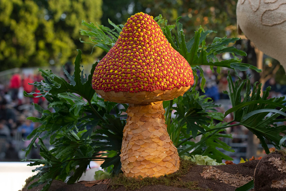A detailed shot of a mushroom figure decorated with flowers.