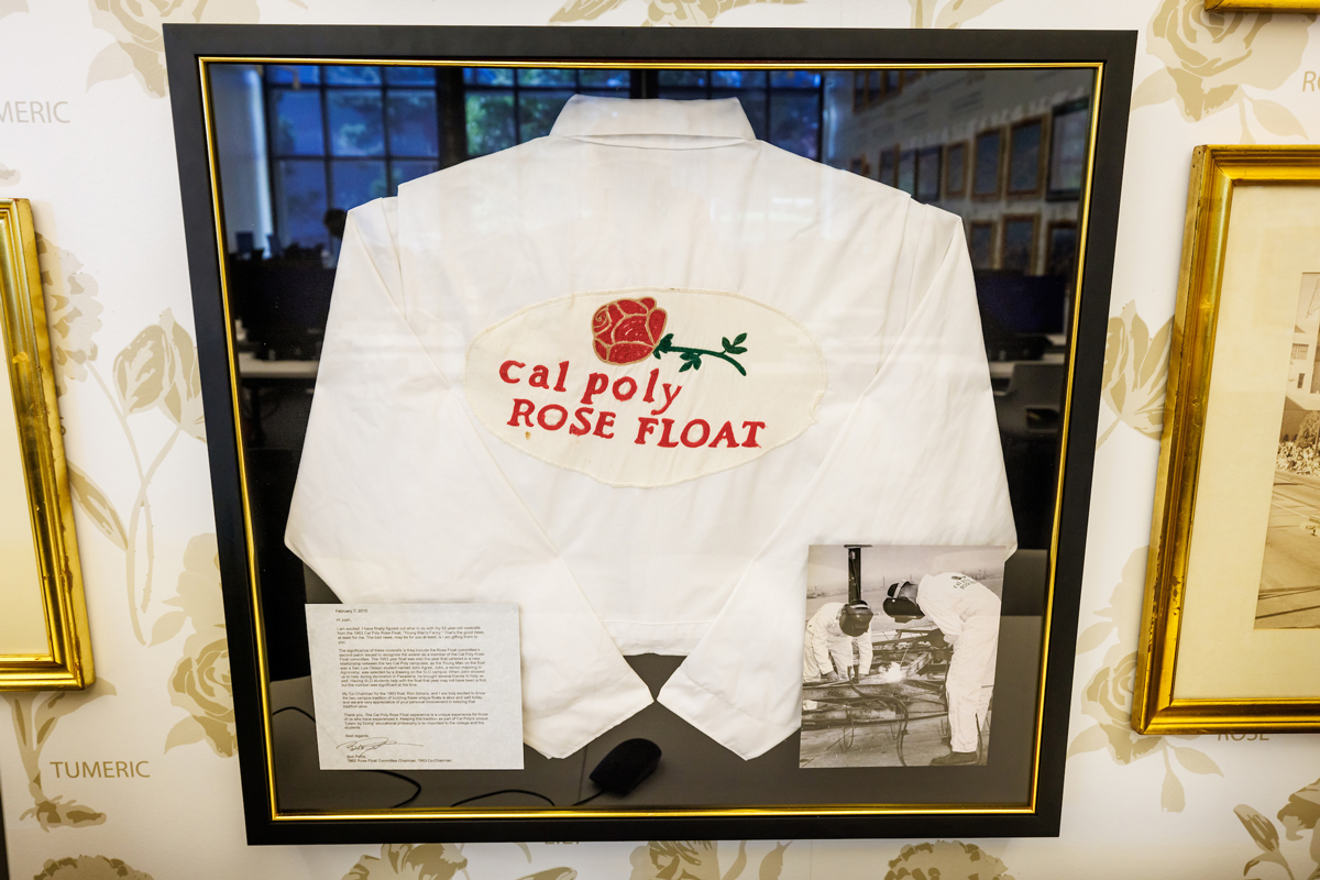 White Rose Float coveralls in a glass display case