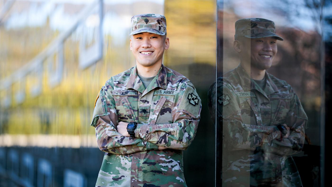 Student Tae Kim wears his Army uniform as he smiles for a picture.