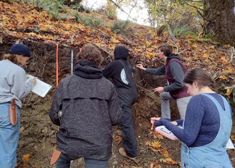 Cal Poly soils students evaluate the dirt seen in an exposed hillside during a competition