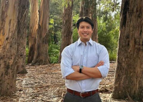 Electrical Engineering Professor Jason Poon standing in a eucalyptus forest