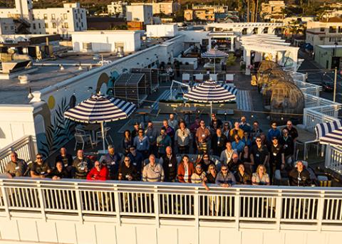 Over 100 members of the University Logistics and Supply Chain Association gather outside at a Pismo Beach hotel for a group photo