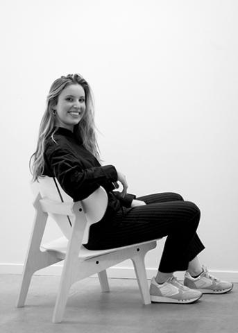 Architecture student Grace Gruverman sits in the Danish chair she designed and built in Copenhagen