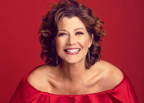 A portrait of a singer Amy Grant in a red dress