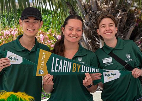 A trio of Cal Poly students hold university penants