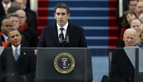 Poet Richard Blanco speaks at the second inauguration of President Obama and then Vice President Biden look on
