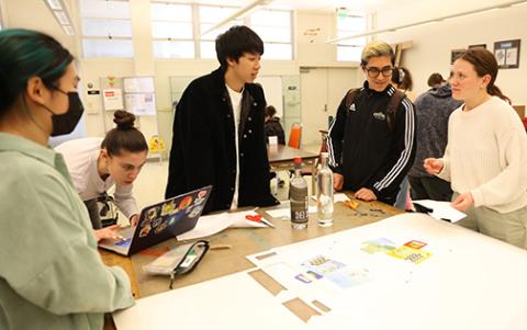 A group of five students work on their award-winning packaging contest entry
