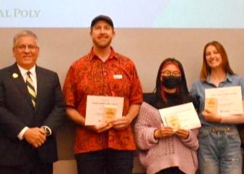 Cal Poly President Armstrong and three students pose with their sustainability awards