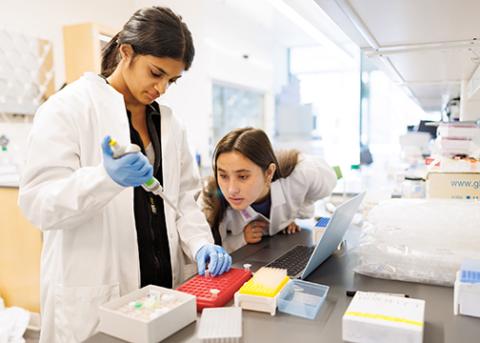 A pair of female Cal Poly students conduct research in a lab setting