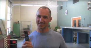 Professor Eric Paton holds a crimping tool in a video he shared with his industrial and manufacturing engineering students.