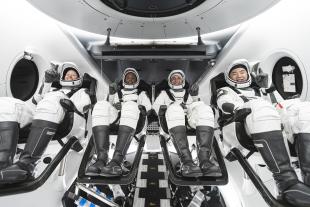 NASA astronauts Shannon Walker, Victor Glover, and Mike Hopkins, and Japan Aerospace Exploration Agency astronaut Soichi Noguchi seated in the SpaceX Crew Dragon vehicle
