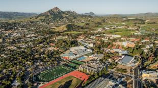 An aerial photo of the Cal Poly campus on on a sunny day with Bishop Peak