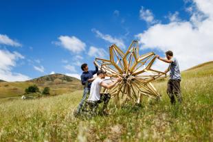 Students set up a spherical structure at Poly Canyon.
