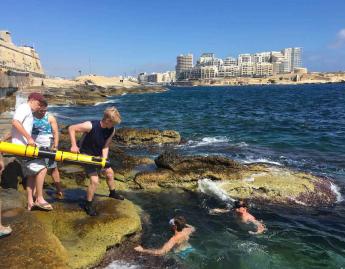 Students work on the coast of Malta.