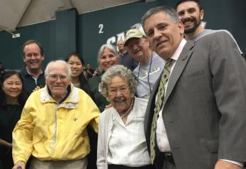 Everett Chandler, 98, and Arlene Chandler, 92, with President Armstrong at a Cal Poly basketball game.