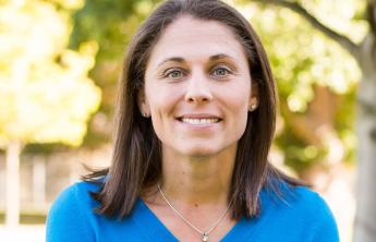 Megan Guise, a professor in Cal Poly’s School of Education, poses for a headshot in a blue shirt.