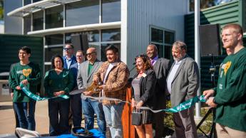 Students and coordinator Kari Leslie cut the ribbon on the new Center for Military Connected Students at Cal Poly.